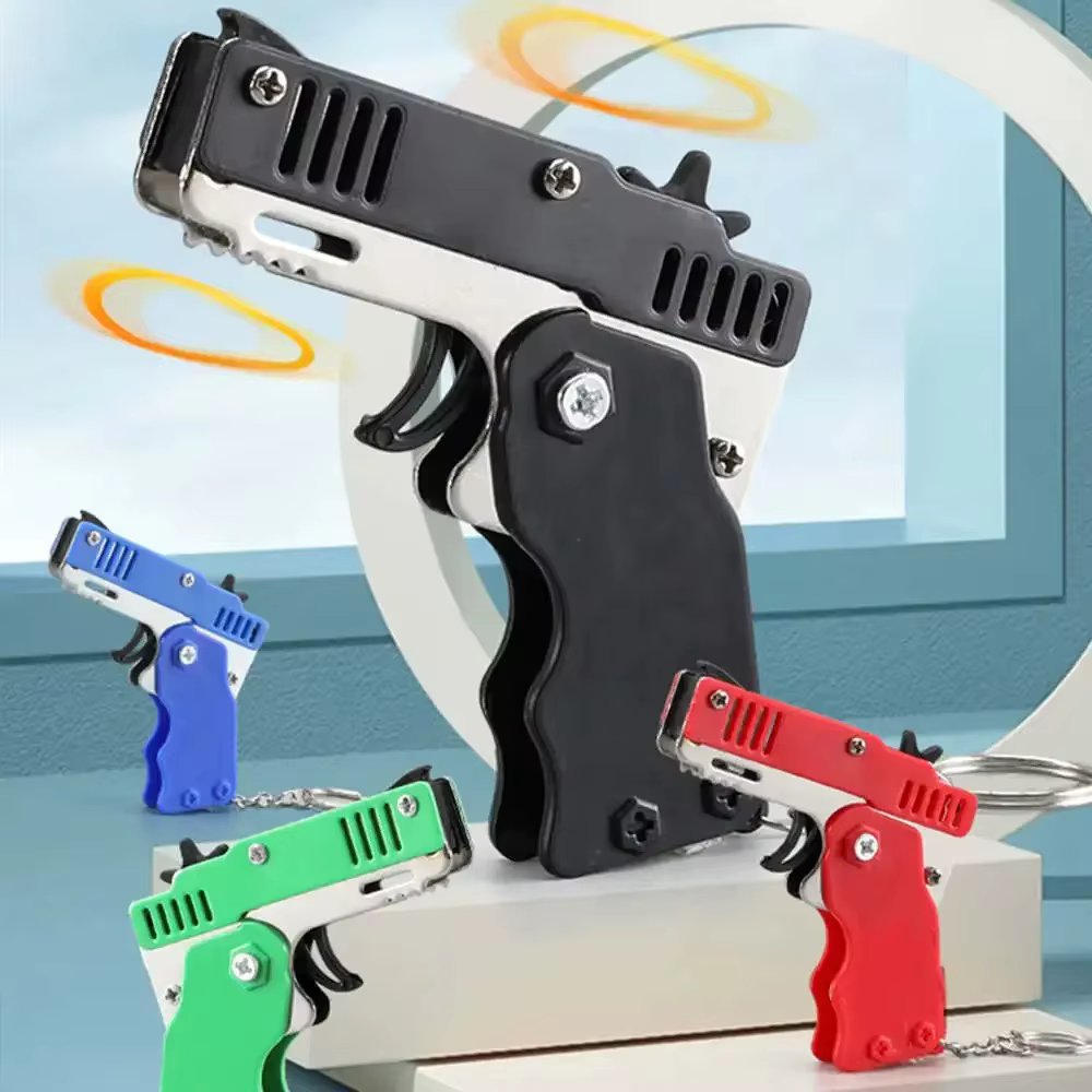 Wholesale Mini Rubber Bands Shoot Gun Alloy Material Multi Function 6 Colors Key Chain Collapsible Funny Mini Gun Toys For Kids